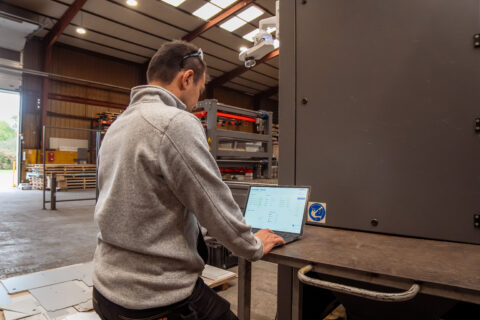 Portrait of Benjamin, CEO of Inspemon, standing inside a warehouse.