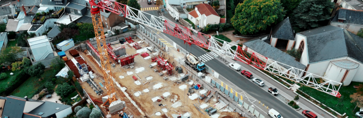 Industrial construction site with a crane overlooking ongoing work, showing infrastructure development in progress.