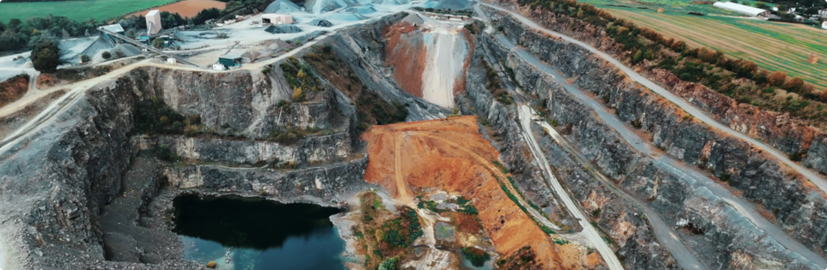 Aerial view of a quarry, showing excavation areas and industrial operations from above.